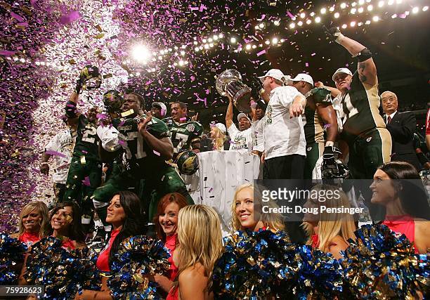 Head coach Darren Arbet of the San Jose SaberCats holds up the Foster ArenaBowl Trophy as the SaberCats celebrate their 55-33 victory against the...