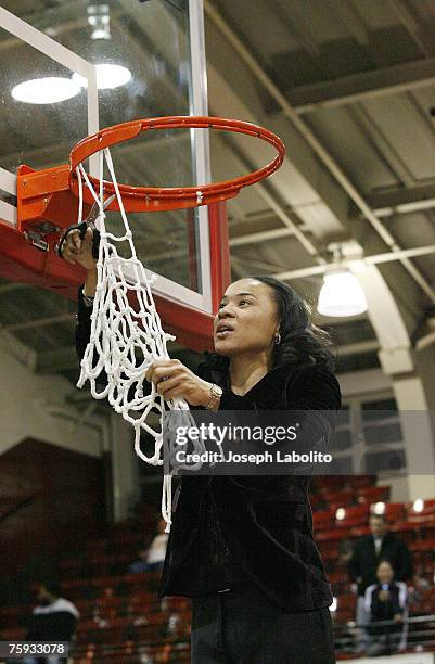 Head coach Dawn Staley cuts down the nets on her third consecutive A-10 title. The Temple Lady Owls defeated the George Washington Colonials 59 to 54...