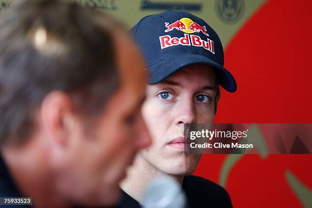 Sebastian Vettel of Germany and Scuderia Toro Rosso sits in the paddock with Gerhard Berger during the Hungarian Formula One Grand Prix Previews at...