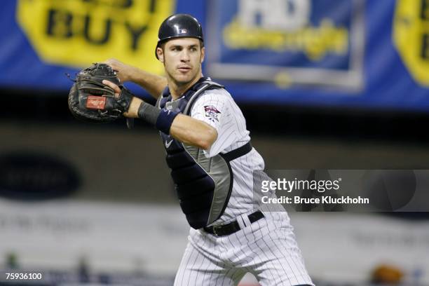 Joe Mauer of the Minnesota Twins throws the ball in a game against the Los Angeles Angels at the Humphrey Metrodome in Minneapolis, Minnesota on July...