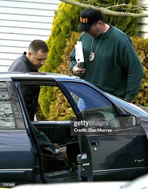 Ocean County, NJ, sheriff's officers investigate the scene of Seaside Heights, NJ police officer Edward Lutes dead in his car April 10, 2002 in...