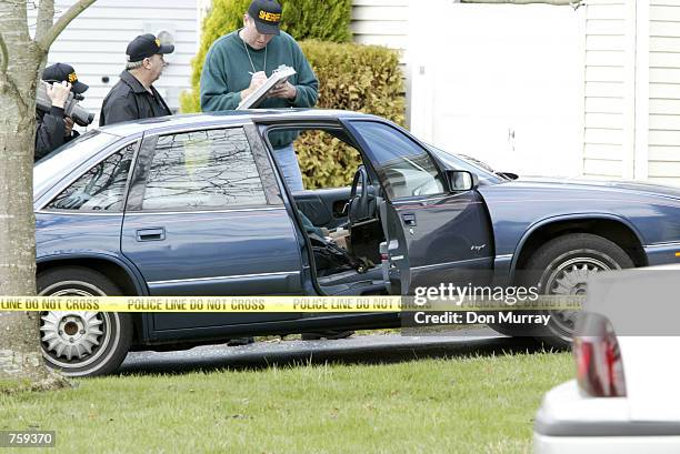 Ocean County, NJ, sheriff's officers investigate the scene of Seaside Heights, NJ police officer Edward Lutes dead in his car April 10, 2002 in...