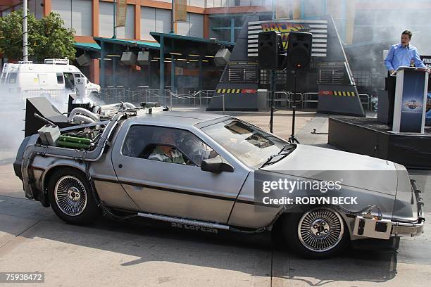 Actor Christopher Lloyd arrives in a DeLorean car at Universal Studios Hollywood's "Back to the Future - The Ride" in University City, California, 02...
