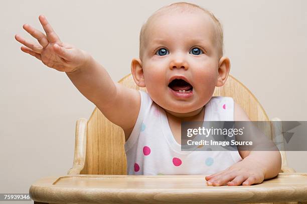 baby reaching out - high chair stock pictures, royalty-free photos & images