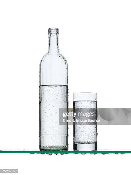 sparkling water in a bottle and a glass - drinking glass bottle stock pictures, royalty-free photos & images