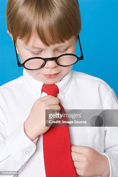boy adjusting tie - adjusting blue tie stock-fotos und bilder
