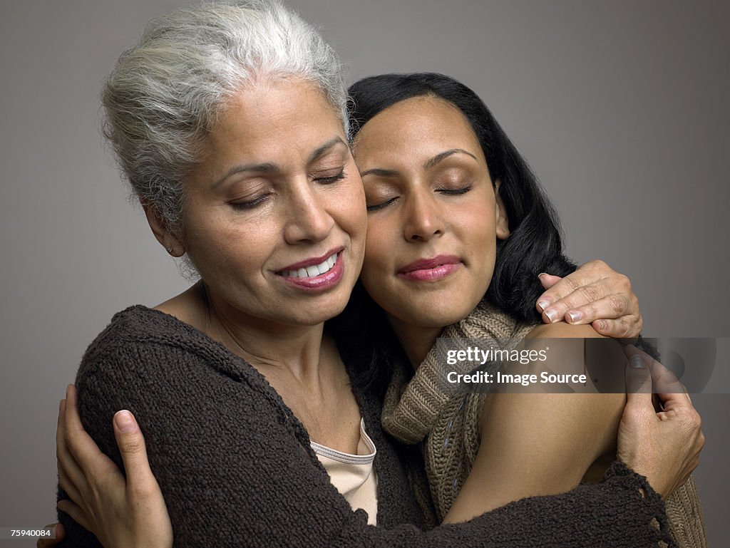 Mother and daughter hugging