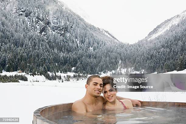 couple in a hot tub near mountains - zillertal stock pictures, royalty-free photos & images