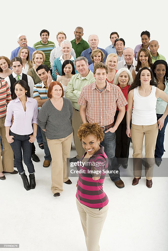 Woman in front of crowd with thumbs up