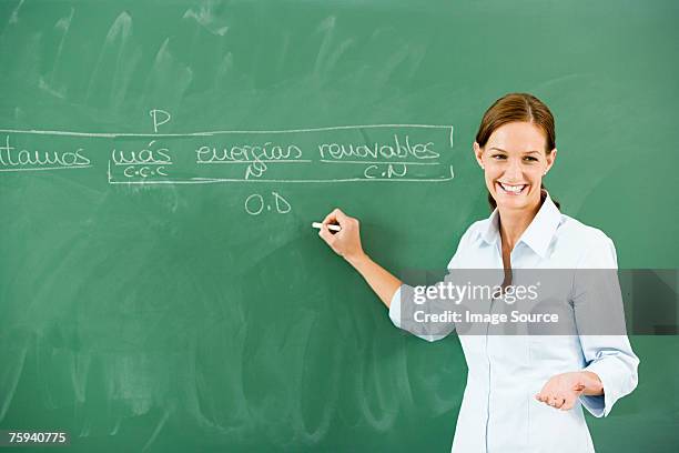 teacher writing on blackboard - spanish culture 個照片及圖片檔