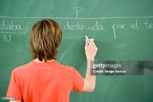 boy writing on blackboard - child writing on chalkboard stock pictures, royalty-free photos & images