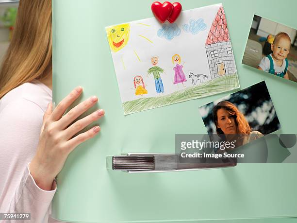 photographs and drawing on refrigerator door - refrigerator stock pictures, royalty-free photos & images