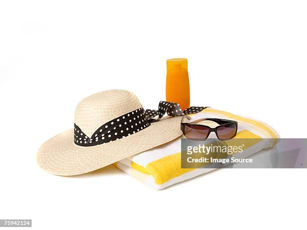 sunglasses beach towel sunhat and suncream - sun hat stock pictures, royalty-free photos & images