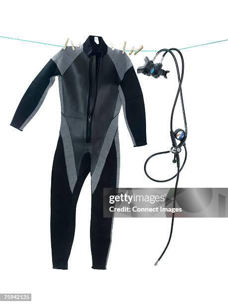 wet suit and diving equipment on washing line - wetsuit stock pictures, royalty-free photos & images