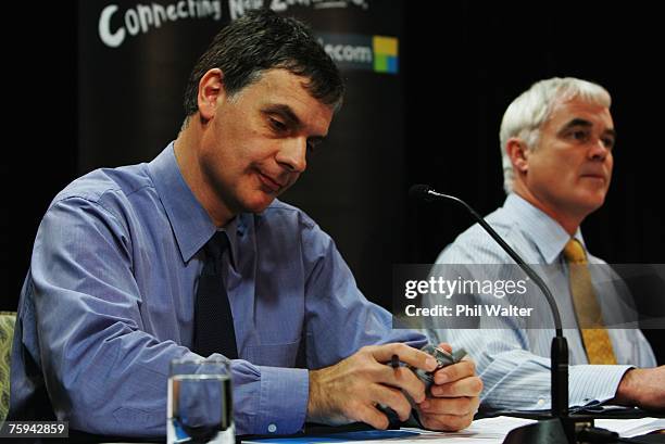 Telecom CFO Marko Bogoievski sends a text message on his phone as Acting CEO Simon Moutter answers questions from the media and shareholders as...