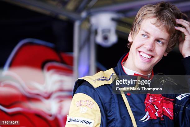 Sebastian Vettel of Germany and Scuderia Toro Rosso prepares in the pits during the Hungarian Formula One Grand Prix Practice at the Hungaroring on...