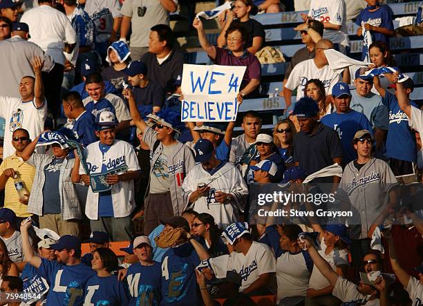 Los Angeles Dodgers fans in the right field pavilion cheer on the Dodgers in game three of the National League Division Series at Dodger Stadium,...