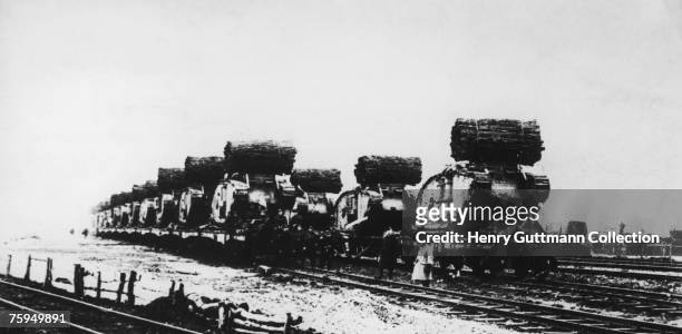 British tanks carrying fascines loaded onto railway wagons ready to take part in the Battle of Cambrai, 20th November 1917. The battle was the first...