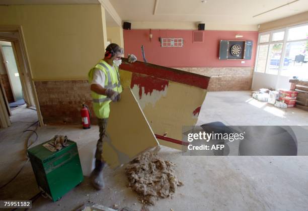 Builders clear out debris in the Canterbury Arms in Tewkesbury on August 3 2007 in Gloucestershire, England. Two weeks ago torrential rain brought...