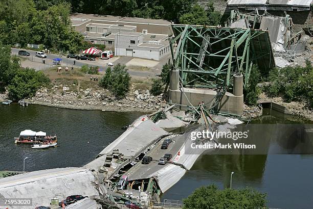 Rescue workers and a dive team work off a barge at the section of the I-35W bridge that collapsed August 3, 2007 in Minneapolis, Minnesota. The eight...