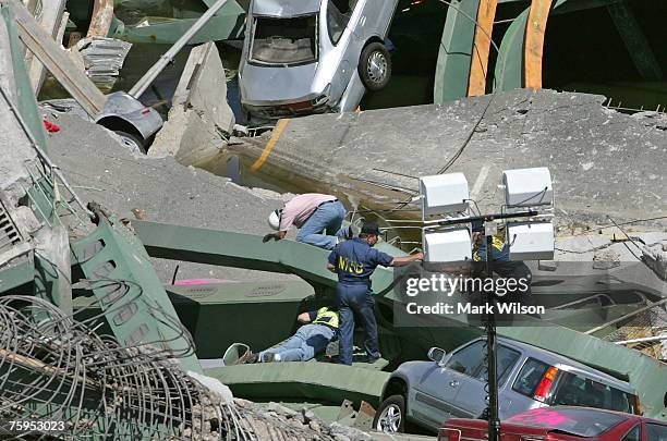 Members of the NTSB examine the section of the I-35W bridge that collapsed August 3, 2007 in Minneapolis, Minnesota. The eight lane steel and...