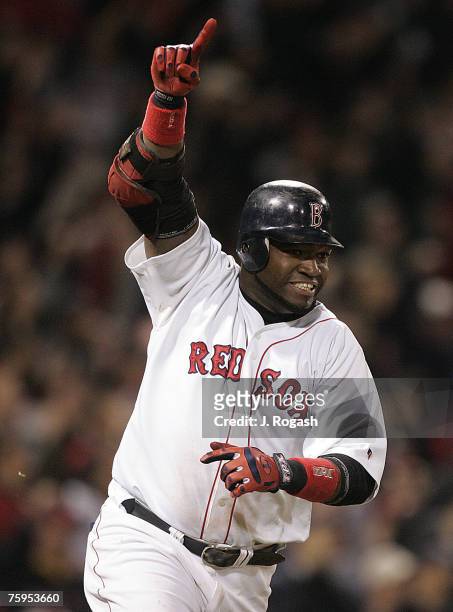 Boston Red Sox batter David Ortiz connects for a game-winning single in the 14th inning, which knocked in the winning run, against the New York...