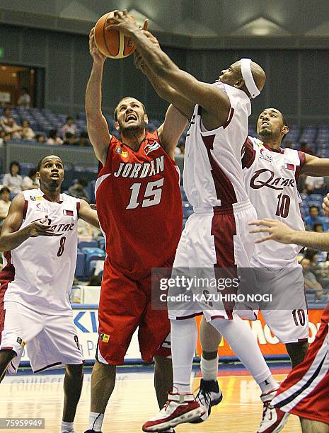 Jordan's Ayman Idais rebound with Qatar's Ali Saad and Yasseen Musa during their 5-8 place classification match at the Asian men's basketball...