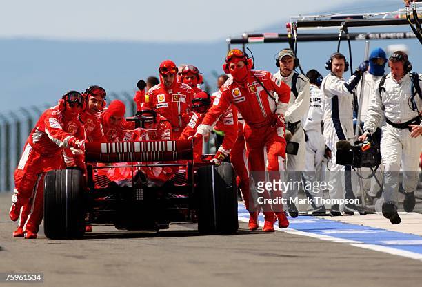 Felipe Massa of Brazil and Ferrari is attended to by his crew in the pits during the Hungarian Formula One Grand Prix Qualifying Session at the...