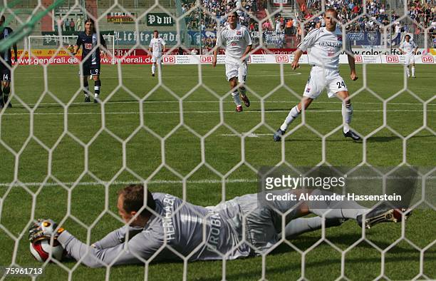Berlin?s keeper Jaroslav Drobny safes a penalty shot by Robert Lechleitner of Unterhaching during the German Football Association Cup first round...