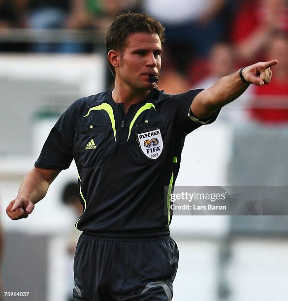 Referee Felix Brych gives a penalty for Stuttgart during the German Football Association Cup first round match between SV Wehen-Wiesbaden and VfB...