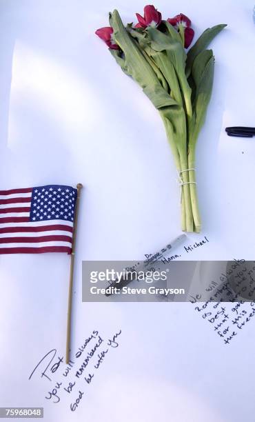Condolences, American flag and a flower sit in front of the San Jose Municipal Rose Garden at a memorial service honoring Pat Tillman, May 3, 2004.