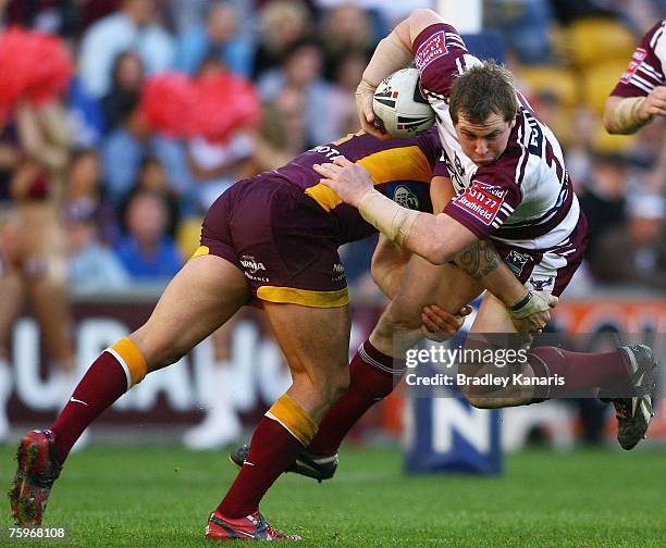 Glenn Hall of the Sea Eagles is tackled by Corey Parker of the Broncos during the round 21 NRL match between the Brisbane Broncos and the Manly...