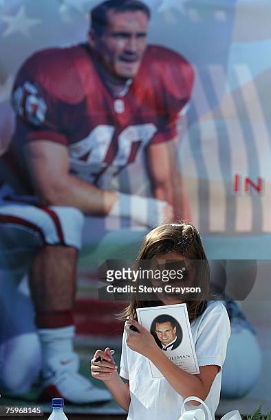 Young lady reads the program for the memorial services for Pat Tillman at the San Jose Municipal Rose Garden May 3, 2004.