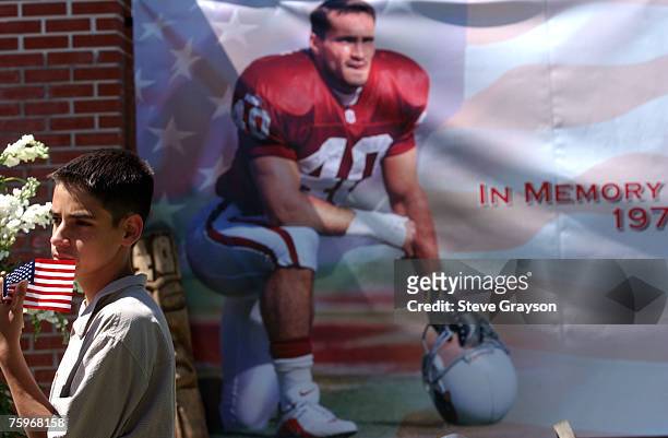 Young boy stops to view a poster of Pat Tillman, the former NFL player who joined the Army Rangers and was killed in action in the Middle East.