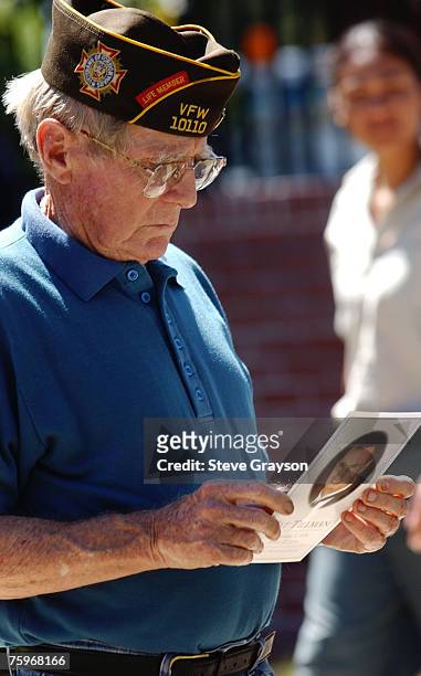 United States war veteran reads the program for the memorial services for Pat Tillman at the San Jose Municipal Rose Garden May 3, 2004.