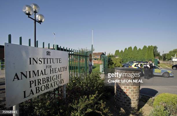 Police officers stand guard outside the Institute for Animal Health Pirbright Laboratory, currently the suspected source of the outbreak of the...