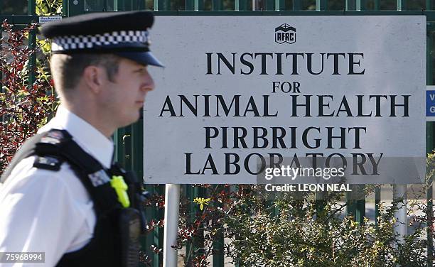 Police officers stand guard outside the Institute for Animal Health Pirbright Laboratory, currently the suspected source of the outbreak of the...