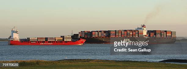 Container ships pass one another on the Elbe River August 3, 2007 at Brunsbuettel, Germany. Northern Germany, with its busy ports of Hamburg,...
