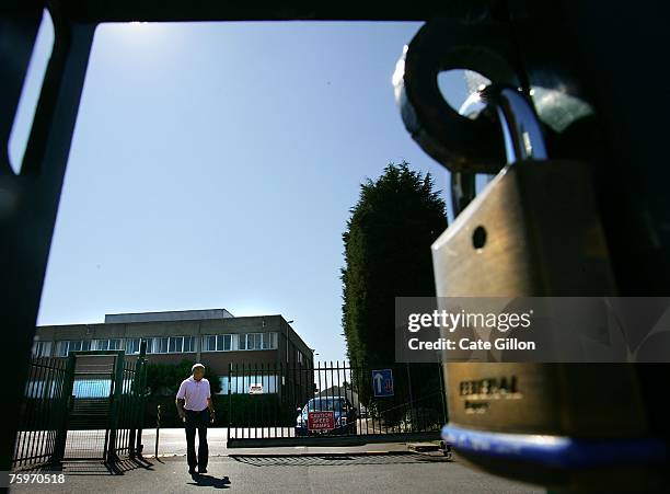 Security man allows a car to leave Merial, the company that produces the foot and mouth vaccine, situated by the Institute for Animal Health...