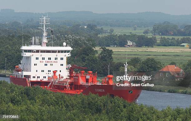 Cargo ship passes along the North Baltic Sea Canal August 3, 2007 at Brunsbuettel, Germany. The canal, first completed in 1895, is 99km long and...