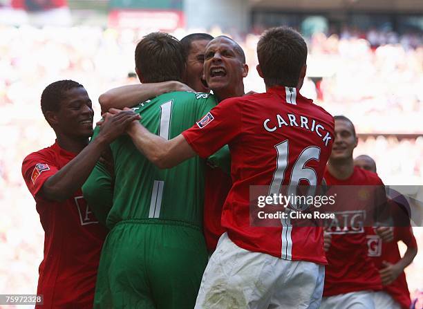 Rio Ferdinand of Manchester United and team mates congratulate Edwin van der Sar as they win the penalty shoot out during the FA Community Shield...