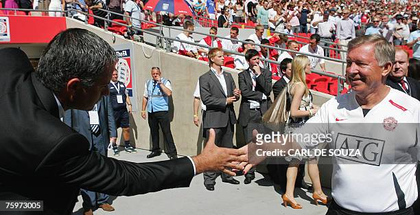 Chelsea's Manager Jose Mourinho shakes hands with Manchester United's Manager Alex Ferguson before their F.A Community Shield match football match at...