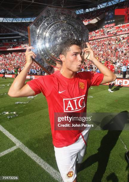 Cristiano Ronaldo of Manchester United poses with the Community Shield after winning the pre-season friendly match between Chelsea and Manchester...