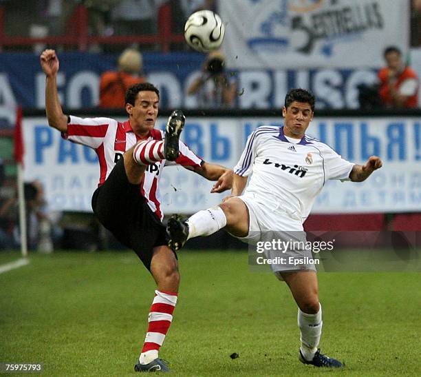 Real's Cicinho competes for the ball with Bakkal Otman of FC PSV Eindhoven during the Railways Cup final between Real Madrid and PSV Eindhoven at the...