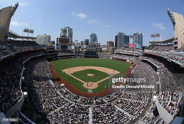 Rob Mackowiak of the San Diego Padres slides into home safe past the tag of catcher Guillermo Rodriguez of the San Francisco Giants during the bottom...