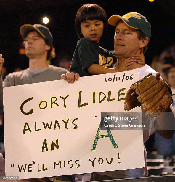 An Oakland A's fan holds a sign in memory to the former Major League pitcher who was killed in an airplane crash In New York, New York on October 11...