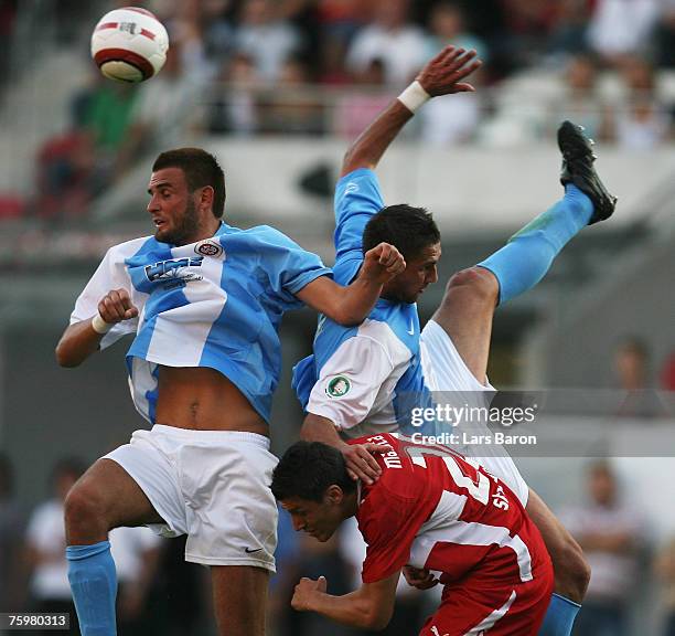 Vlado Jeknic and Dajan Simac of Wehen in action with Ciprian Marica of Stuttgart during the German Football Association Cup first round match between...