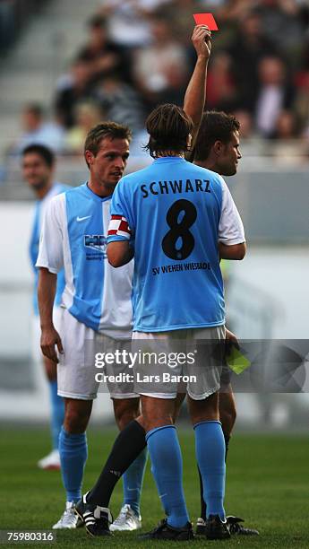 Referee Felix Brych shows Sandro Schwarz of Wehen the red card during the German Football Association Cup first round match between SV...