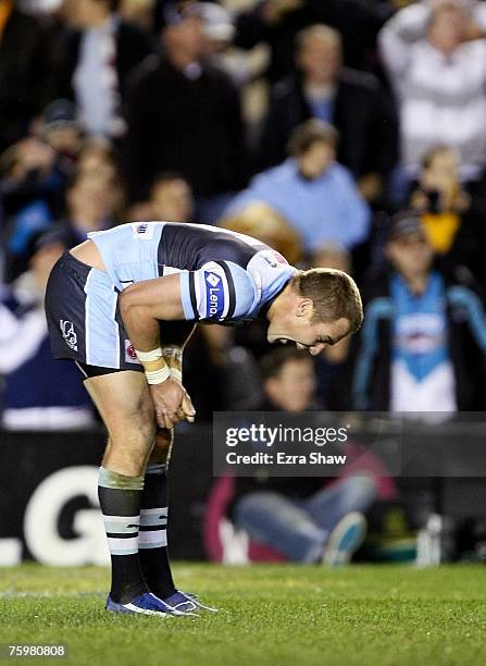 Luke Covell of the Sharks reacts after he missed a field goal that would have tied the game during the round 21 NRL match between the...