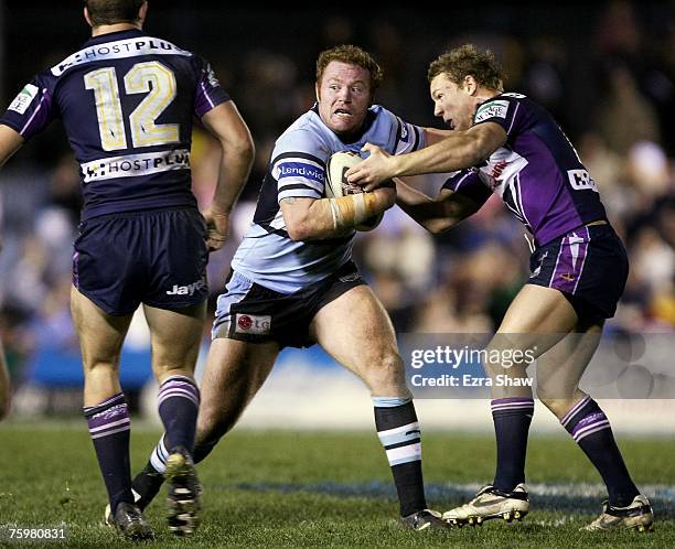 Craig Stapleton of the Sharks is tackled during the round 21 NRL match between the Cronulla-Sutherland Sharks and the Melbourne Storm at Toyota Park...